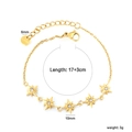 Detailed view of gold bow bracelet with star charms, zircon stones, and size dimensions - Gold (BR29120AG)