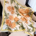 Dettaglio di un elegante foulard quadrato con rose arancioni su tessuto satinato - Beige