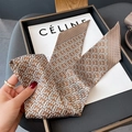 Close-up of geometric pattern silk twilly scarf in orange and brown for hair or neck - Thin Long Style / Khaki
