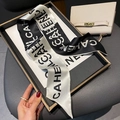 Dettaglio di un elegante foulard di seta bianco e nero con stampa di lettere su una borsa - Beige-Nero