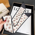 Close-up of floral print silk twilly scarf with black edges on a beige leather bag - 7*90cm / Black Border Beige Pink Floral