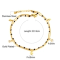 Detail eines doppellagigen vergoldeten Fußkettchens aus Edelstahl mit Sternen und Perlen - Doppellagige Sternenschwarze Perle (AN112801G)