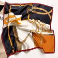 Silk scarf with equestrian bridle print in navy and orange draped over magazine - 53*53cm / Beige-Black