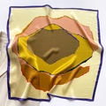 Detailed view of glossy silk square scarf with abstract patterns on a beige blazer - 70x70cm / Lemon Yellow