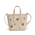 Cream-white mini tote bag featuring gold heart-shaped diamond studs and top handles - White