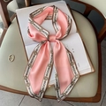 Pink narrow silk scarf with golden chain print tied in a bow on a vintage book - Pink Chain Watch (FX-193)