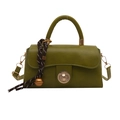 Retro green minimalist square handbag with metal lock and decorative charm on white background - Green with Charm