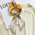 Elegant floral print silk scarf in yellow and cream shown tied on a soft knit top - Silver Gray Edge