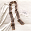 Macro shot of a silk leopard pattern twilly scarf paired with a white satin dress - Khaki Houndstooth Pattern (DT-15)