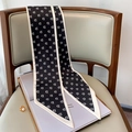 Detail of black and white skinny scarf with letter D pattern draped on a chair - 15*150cm / Black (FX-174)