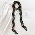 Elegant emerald green silk twilly scarf with geometric fox pattern on white dress - Dark Green Fox Geometric Pattern