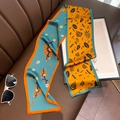 Detail of a dual-sided floral silk skinny scarf on a brown leather texture - 15*150cm / Bright Yellow Blue
