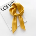 Ginger yellow silk satin square scarf shown tied on a white magazine background - 65x65cm / Yellow
