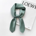 Detail of sage green silk satin scarf tied as a bow on a white magazine background - 65x65cm / Aqua Green