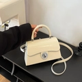Chic cream leather box bag with round metal lock and shoulder strap for elegant women - White