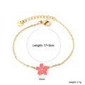 Detail of pink cherry blossom pendant on a gold stainless steel adjustable chain - Single Cherry Blossom Bracelet (BR27140FG)
