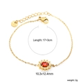 Gold stainless steel bracelet featuring a sunflower pendant with a red oval zircon center - Gold Red Gem Sunflower Style (BR27620EG)