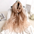 Brown striped long scarf with wavy edges paired with a white shirt and dark handbag - Striped Plaid Khaki