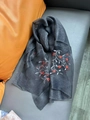 Dark grey sheer silk scarf with delicate floral embroidery on a soft leather background - Floral Embroidery Black