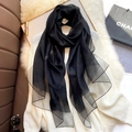 Elegant semi-transparent black silk blend scarf styled over a white knit sweater - Elegant Black