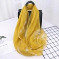 Elegant ginger yellow silk blend scarf with thin silver stripes draped on a black bag - Striped Yellow