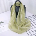 Light green striped silk blend long scarf draped over a black leather handbag - Striped-Green