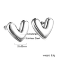Close-up of antiallergic stainless steel heart earrings with polished 3D metal finish - Silver Heart Style (EA593201S)