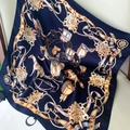 Navy blue silk scarf with gold carriage print elegantly draped on a beige chair - 53x53cm / Navy Blue