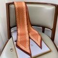 Close-up of geometric orange silk scarf with paisley border on a leather chair - 15*150cm / Caramel color