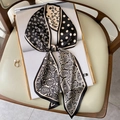 Detailed close-up of silk-textured twilly scarf with classic paisley and polka dot patterns - Khaki Paisley