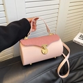 Pink cylinder handbag with textured flap and gold twist lock in crossbody style - Pink