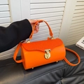Vibrant orange barrel bag with pleated flap design and round gold buckle closure - Orange