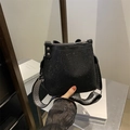 Black rhinestone bucket bag featuring striped wide strap and textured finish - Black