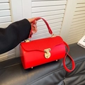 Red cylinder boston handbag with quilted wave pattern and gold metal lock detail - Red