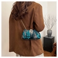 Detailed view of deep teal sequin evening bag with diamond-set lock and gold chain strap - Green