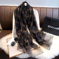 Close-up of lightweight silk blend scarf with metallic gold checkered patterns on black - Black