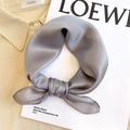 Close-up of a silver-grey silk square scarf tied in a neat bow on a beige shirt collar - 53*53cm / Dark Gray