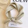 Detail showing smooth silk texture and soft pearlescent luster of champagne gold scarf - 53*53cm / Khaki
