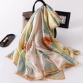 Elegant floral silk-feel scarf with botanical print draped over a stylish handbag - Faux Silk / Light Yellow Green