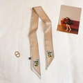 Dettaglio macro di twilly in seta beige con arte astratta e bordo a contrasto - Beige