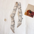 Detail of artistic face line print scarf with a gold ring buckle on white fabric - TLP-71 Beige (Abstract Face)