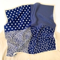 Detail of silk square scarf showing paisley patterns and dots on navy blue fabric - Navy Blue