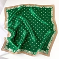 Detail of silk square scarf featuring emerald green polka dots and paisley patterns - Green