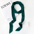 Close-up of emerald green satin skinny scarf with smooth texture and neat stitching - Dark Green