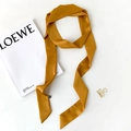 Detail of elegant ginger yellow satin skinny scarf styled with fashion magazine - Ginger Yellow