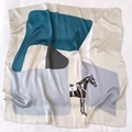 Detailed macro view of large silk scarf with carriage motif and geometric color blocking - 90cmx90cm / Peacock Blue
