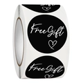 Close-up of black round sticker with white Free Gift text and heart for gift packaging - Black / 1 Inch / 2.5cm