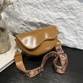 Caramel brown leather saddle bag with wide blue geometric woven shoulder strap - Brown