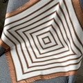 Elegant geometric silk scarf with caramel and black stripes on a grey fabric chair - 53x53cm / Striped Beige