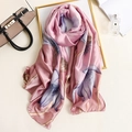 Pink lotus print silk scarf with satin finish displayed with fashion accessories - 90x180cm / Pink
